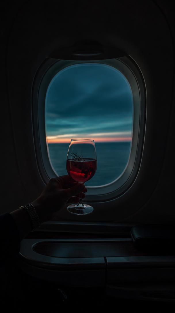 A guest raising a BloomCraft serve beside a cabin window at dusk